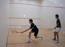 Two boys playing squash