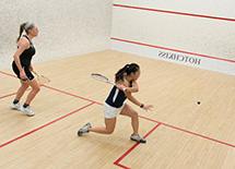 two girls playing squash